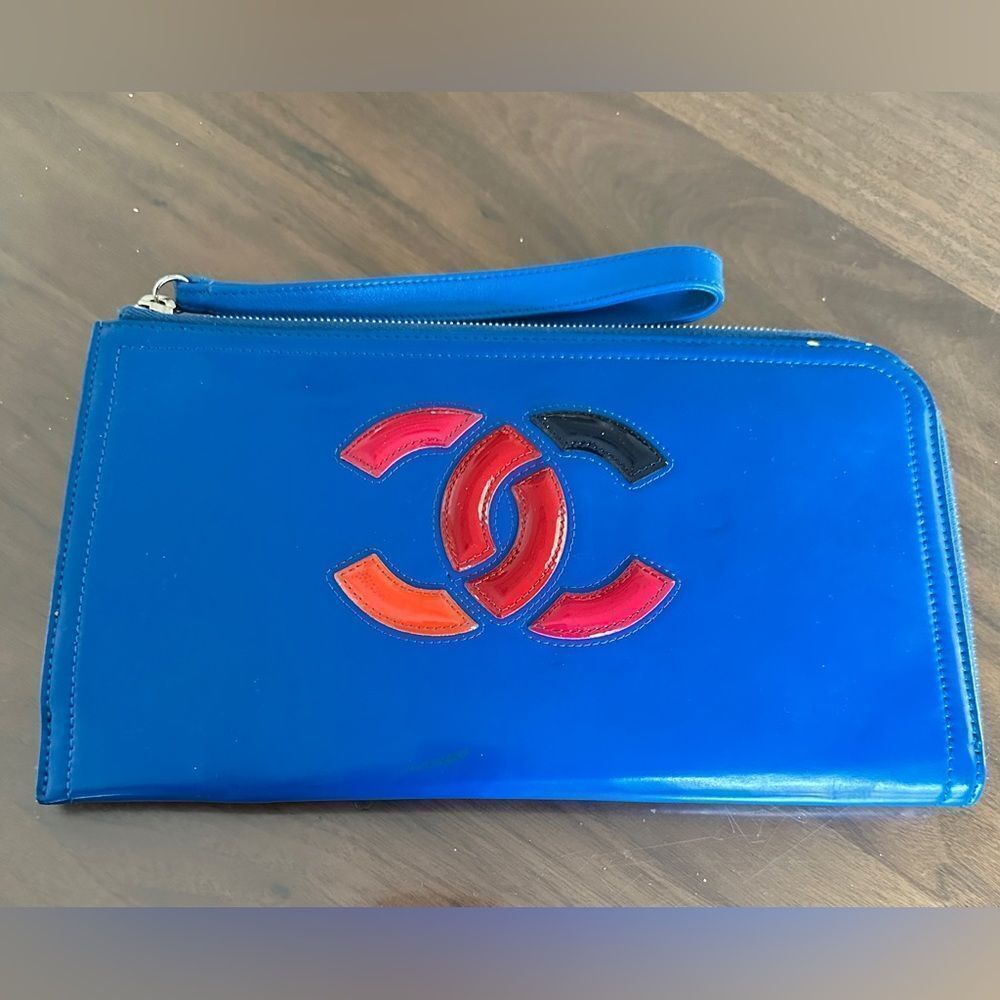 AUTHENTIC Chanel dark blue, lipstick, wristlet patent leather clutch with strap.